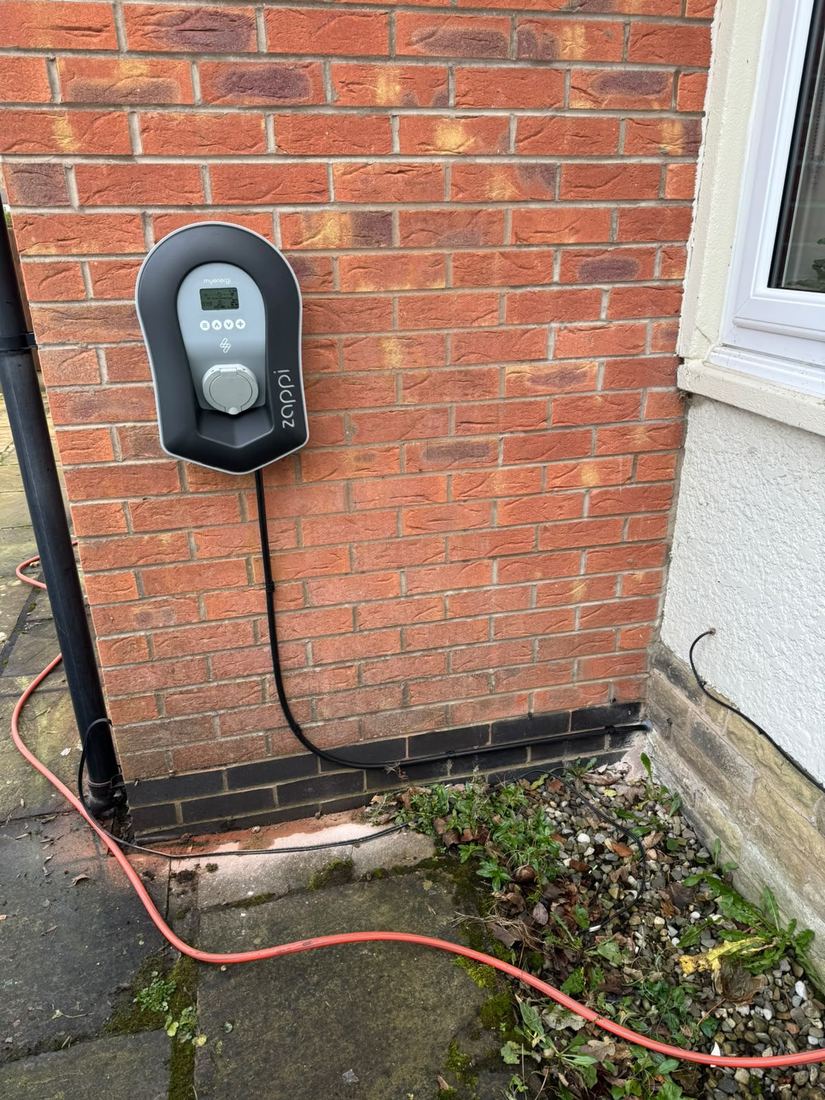 myenergi Zappi EV charger installed on brick wall