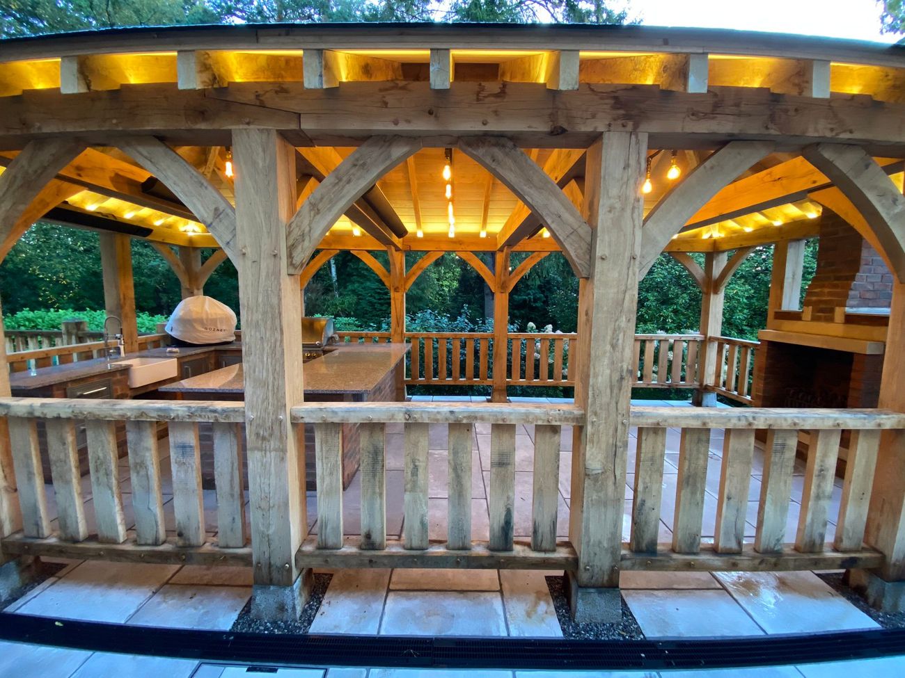 Oak-framed outdoor kitchen with integrated lighting