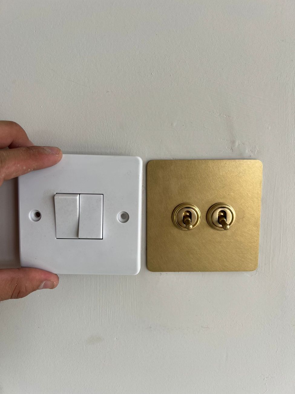 Old switch compared with a new upgraded switch during a rewire